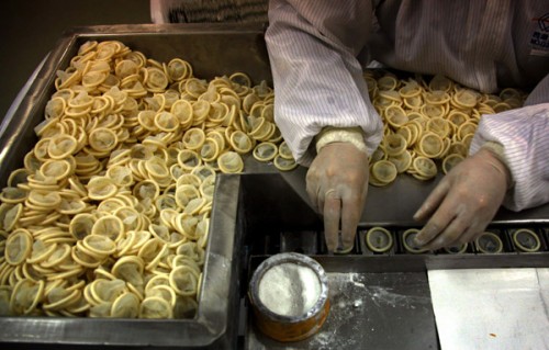 A worker places condoms onto a packaging belt at the Chinese condom manufacturer Safedom's factory